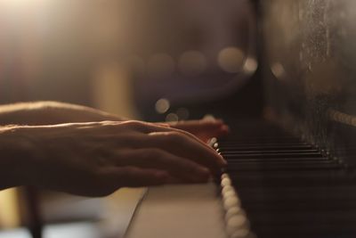 Close-up of hands playing piano