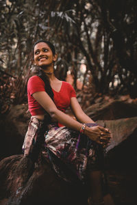 Portrait of a smiling young woman sitting outdoors