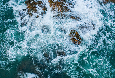 High angle view of water splashing in sea