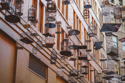 Low angle view of lanterns hanging on wall in building