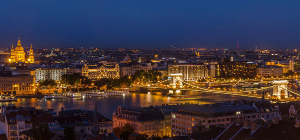 High angle view of szechenyi chain bridge over danube river amidst illuminated city