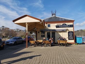 People on street in city against sky