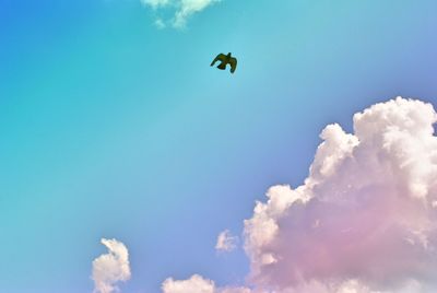 Low angle view of airplane flying against blue sky