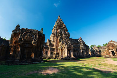 Old temple building against blue sky