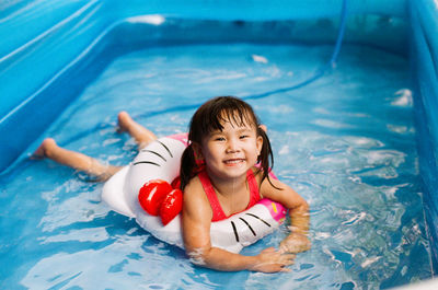 Portrait of smiling boy swimming in pool