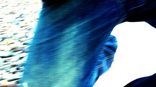 Close-up of woman against blue sky