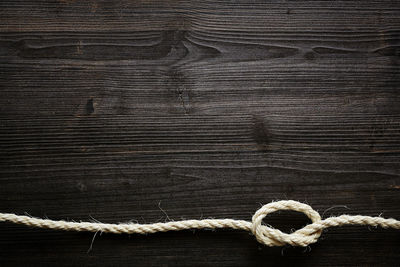 Close-up of rope on wooden plank