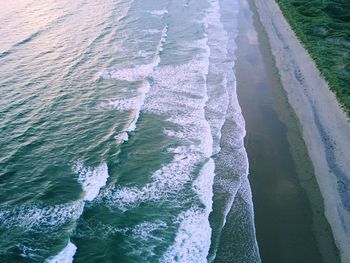 Aerial view of waves in sea at beach