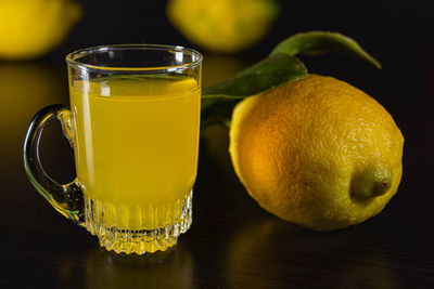 Close-up of yellow glass on table