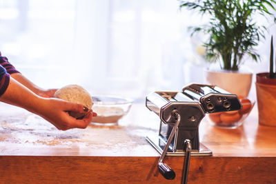 Midsection of woman preparing food at home