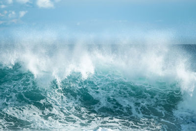 Close-up of sea waves against blue sky