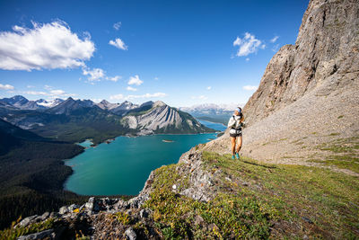 Hiker walking sarrail ridge above upper kananaskis lakes in kananaskis