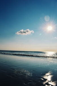 Scenic view of sea against bright sun