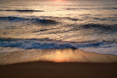 Scenic view of beach against sky during sunset