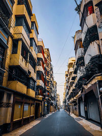 Street amidst buildings against sky in city