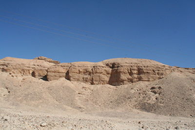 Rock formations in desert against clear blue sky