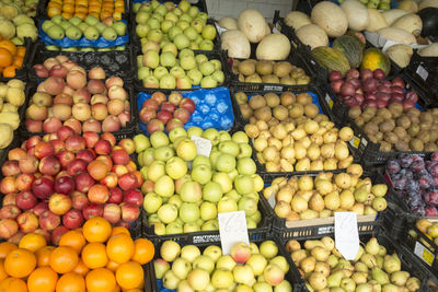 Various fruits in crates for sale at market stall