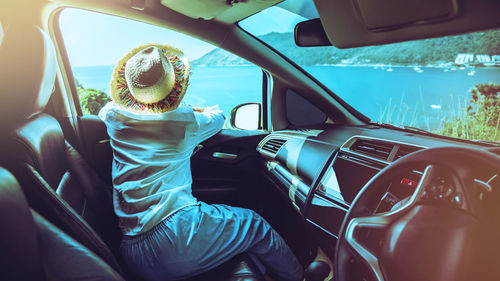 Midsection of man sitting in car