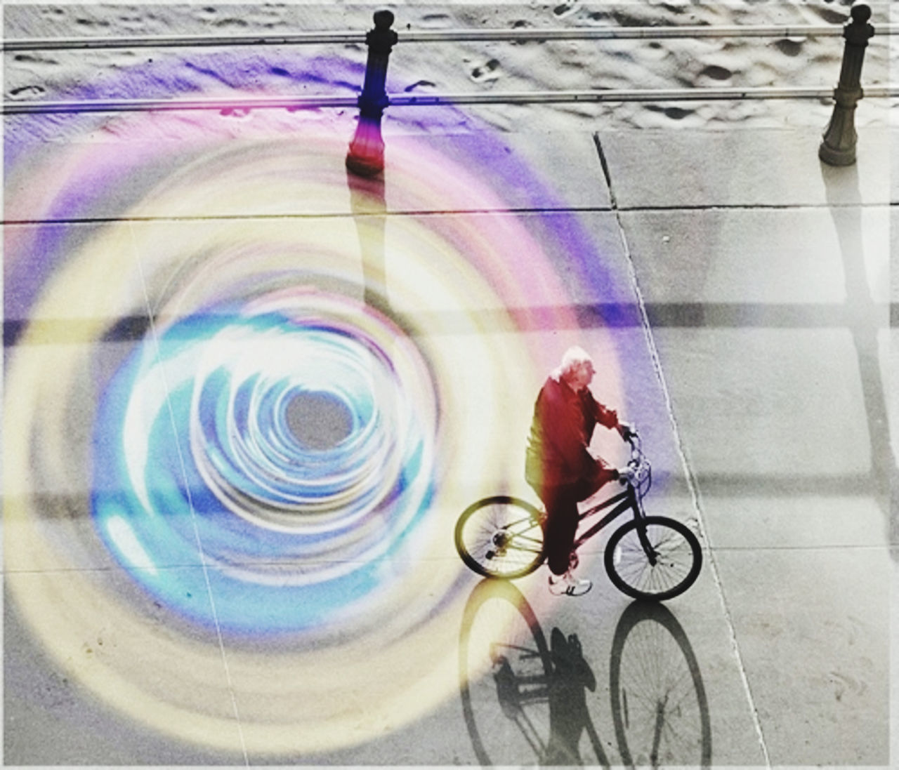 BLURRED MOTION OF MAN RIDING BICYCLE ON CITY