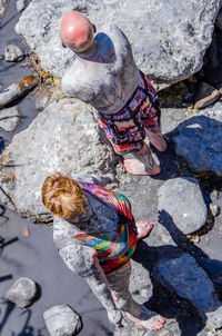 High angle view of people on rock