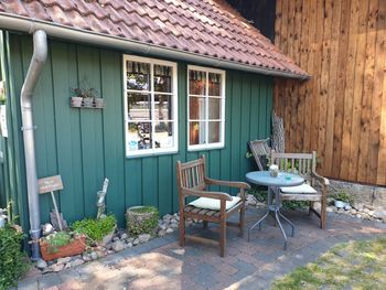 Chairs and table outside house in yard