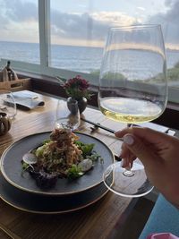 Cropped hand of person preparing food on table