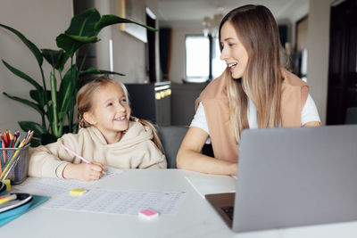 Young woman using laptop at home