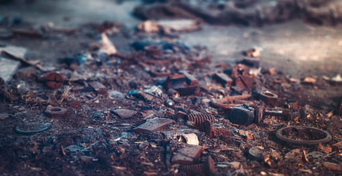 Close-up of rusty metal on field