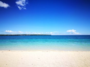 View of beach against blue sky