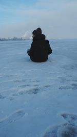 Silhouette person in sea against sky