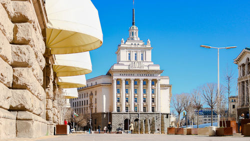 Buildings in city against clear sky