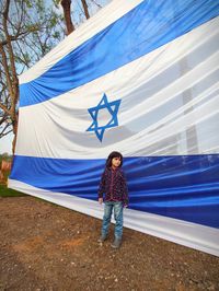 Full length of girl standing by israel flag