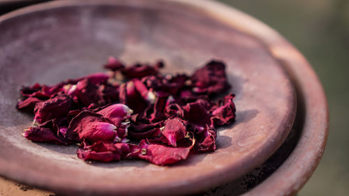 Close-up of dry rose petals on container