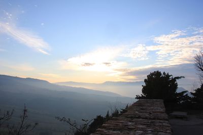 Scenic view of mountains against sky at sunset