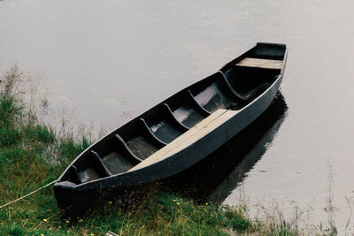 Old wooden boat moored by the river