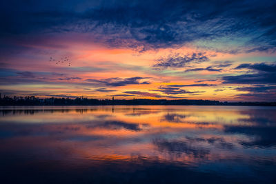 Scenic view of lake against romantic sky at sunset