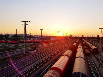 High angle view of trains on railroad track against sky during sunset