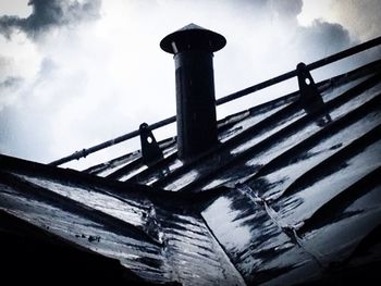 Low angle view of building against cloudy sky