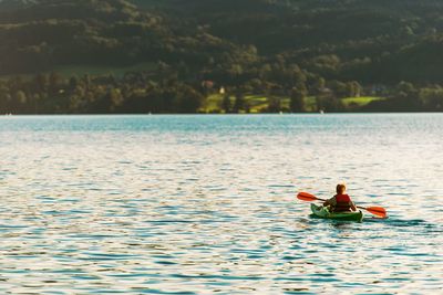 Woman rowing boat in lake