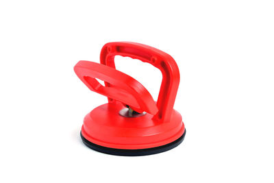 Close-up of red telephone over white background