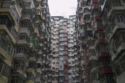 Low angle view of buildings in city against sky, hong kong