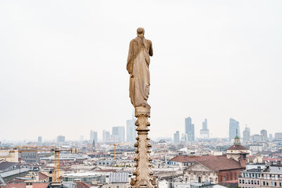 Statue of liberty against buildings in city