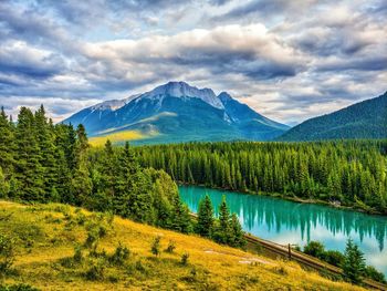 Scenic view of lake and mountains against sky