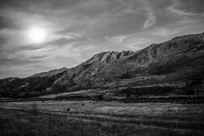 Scenic view of mountains against cloudy sky