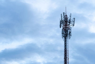 Low angle view of communications tower against sky