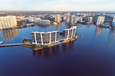 High angle view of river amidst buildings in city against sky