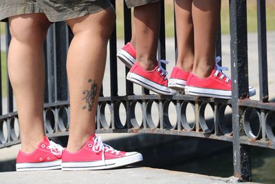 Low section of woman standing on bridge over water