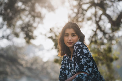 Portrait of smiling young woman standing outdoors