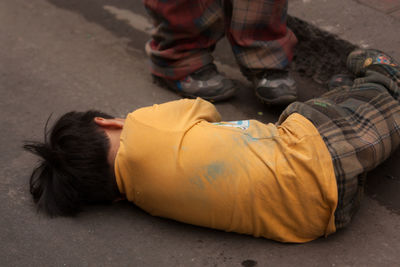 Boy sleeping on street