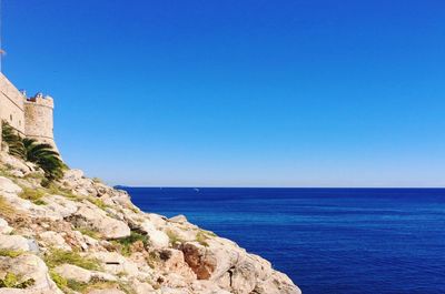 Scenic view of sea against clear blue sky